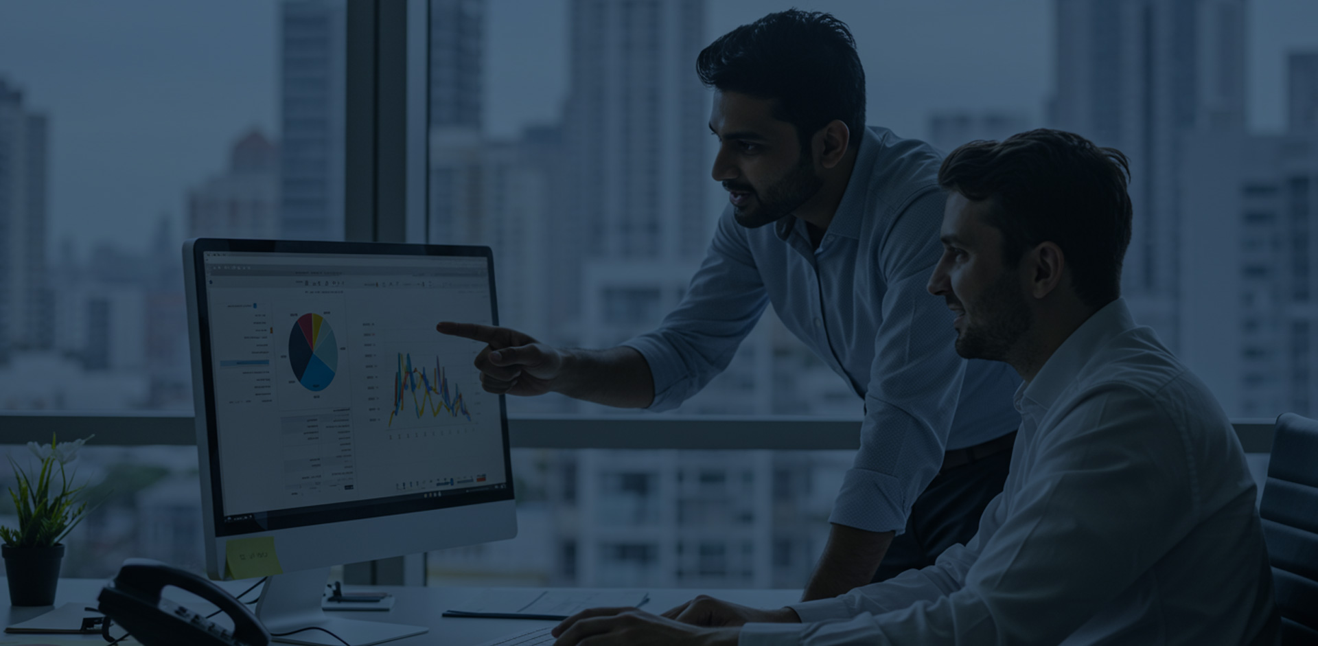 two advisors looking at market results on a computer
