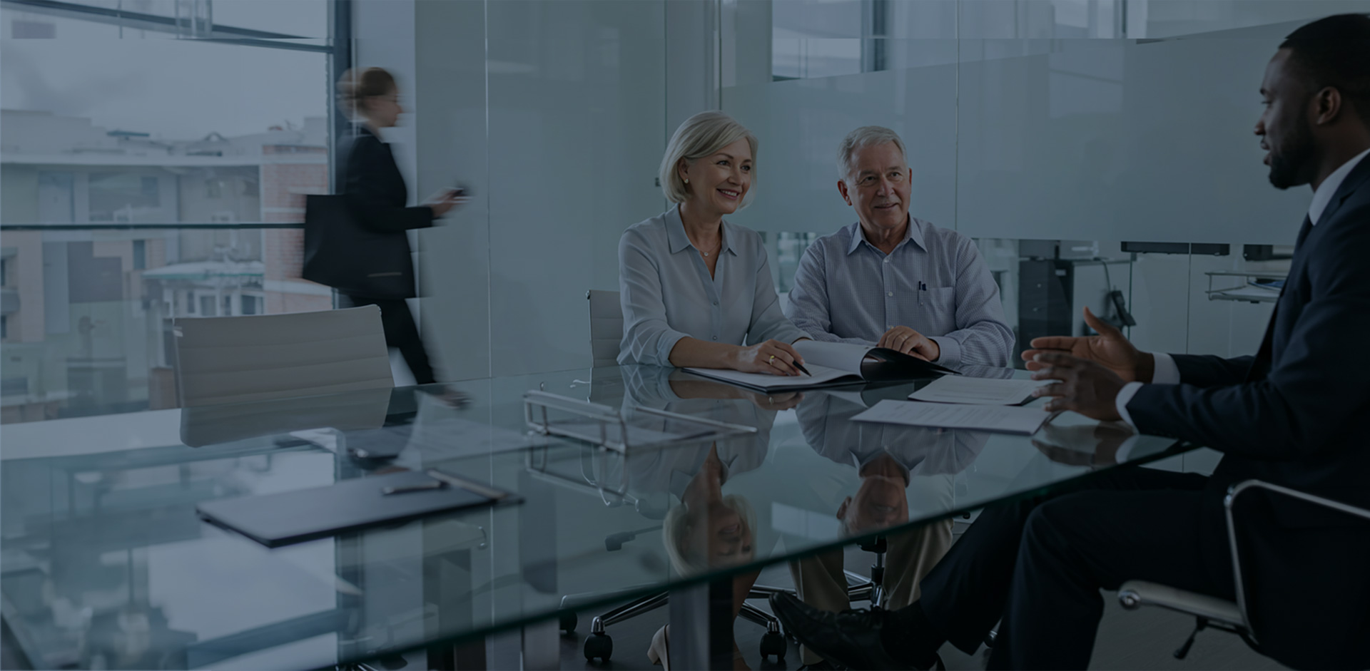 An older couple talking to their advisor in his office